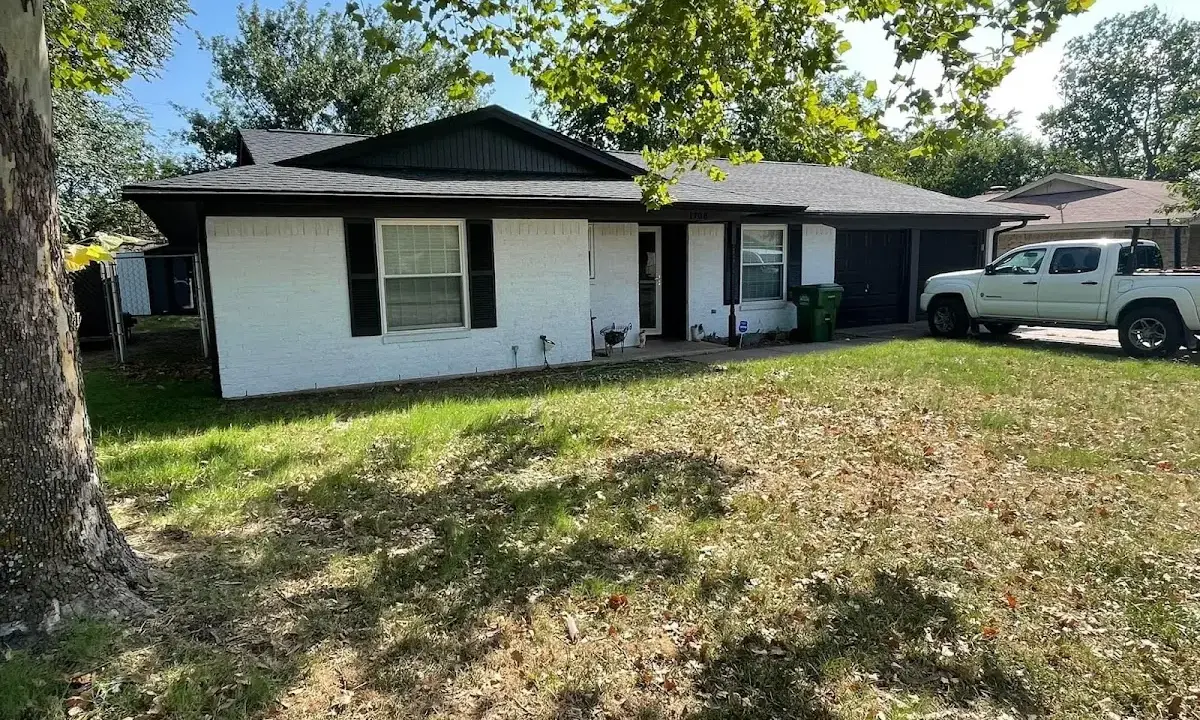 Professional roofing crew working on a residential roof in Georges